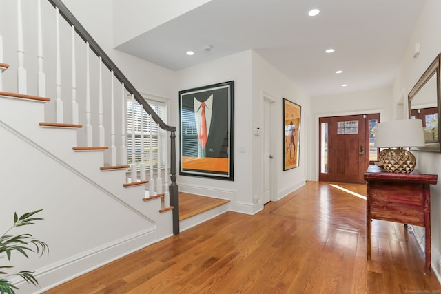 foyer entrance featuring plenty of natural light, recessed lighting, baseboards, and wood finished floors