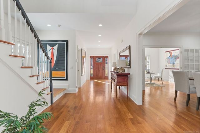 entryway with recessed lighting, baseboards, light wood-style flooring, and stairs