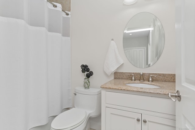 bathroom with a shower with shower curtain, toilet, and vanity