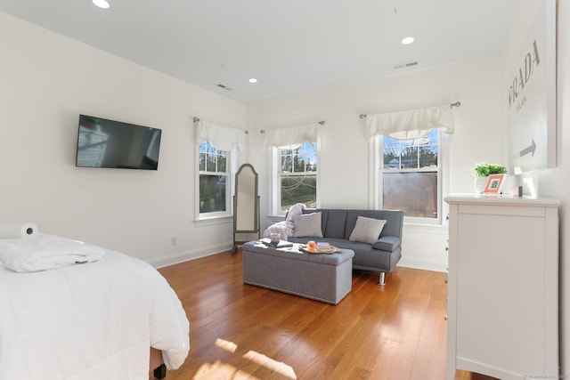 bedroom with light wood-style flooring, multiple windows, and recessed lighting