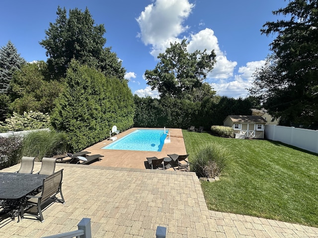 outdoor pool with a shed, an outdoor structure, fence private yard, a patio area, and a lawn