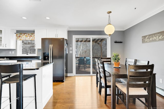 dining room featuring recessed lighting, light wood-type flooring, and crown molding