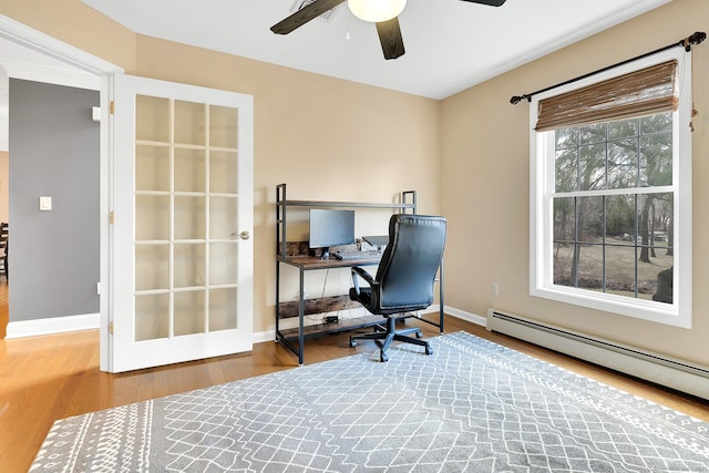 office featuring wood finished floors, baseboards, baseboard heating, and ceiling fan