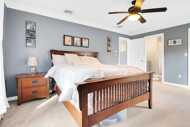 bedroom featuring baseboards, visible vents, and light carpet