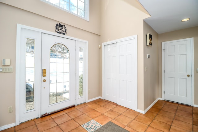 entryway featuring light tile patterned floors and baseboards