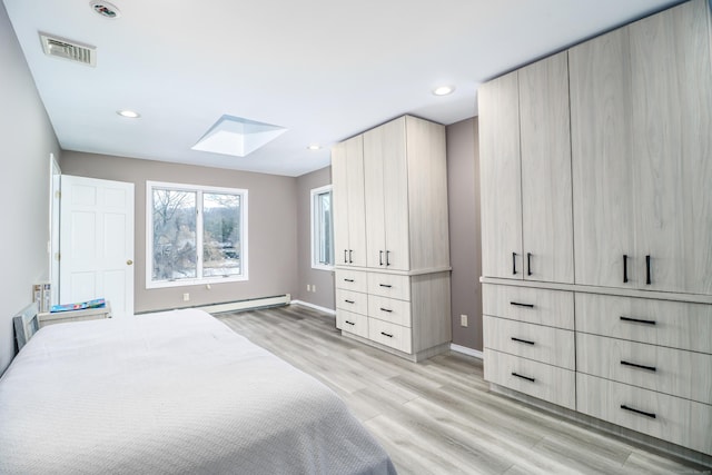 38 N Lake Shore Dr, Brookfield, CT 06804 - bedroom with a skylight, light wood-style floors, baseboards, recessed lighting, and baseboard heating