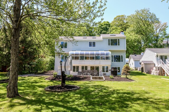 38 N Lake Shore Dr, Brookfield, CT 06804 - back of property featuring a sunroom, a chimney, and a lawn