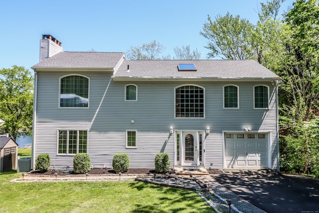 38 N Lake Shore Dr, Brookfield, CT 06804 - rear view of property with a chimney, driveway, a yard, a garage, and central air condition unit