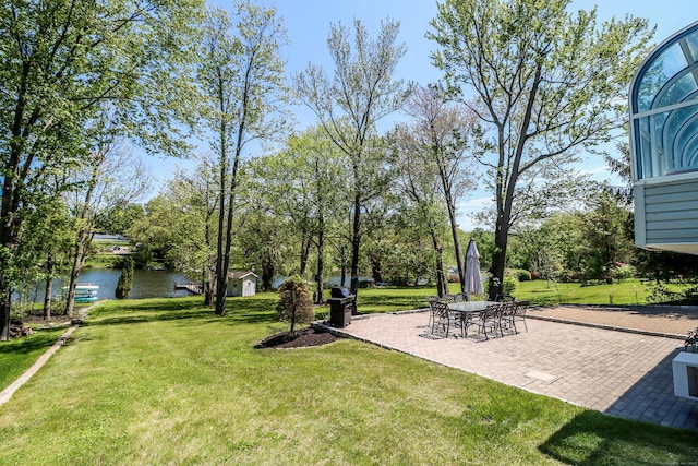 38 N Lake Shore Dr, Brookfield, CT 06804 - view of green lawn featuring a water view, a patio area, and view of wooded area