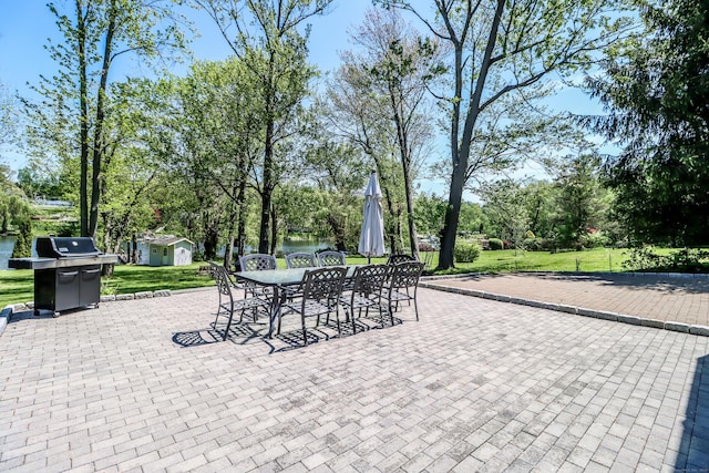 38 N Lake Shore Dr, Brookfield, CT 06804 - view of patio with outdoor dining space, area for grilling, view of wooded area, and a shed