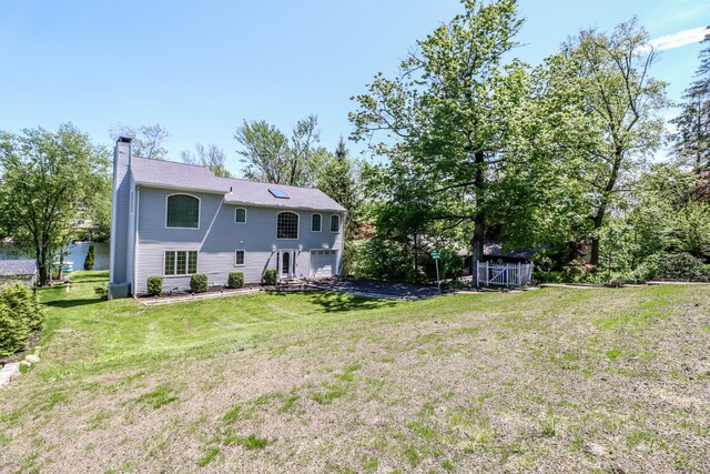 38 N Lake Shore Dr, Brookfield, CT 06804 - rear view of property with a chimney and a yard