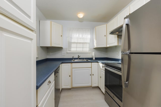 kitchen with a sink, stainless steel appliances, extractor fan, white cabinetry, and dark countertops