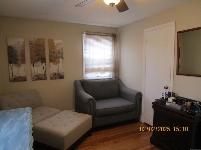 sitting room with a ceiling fan and wood finished floors