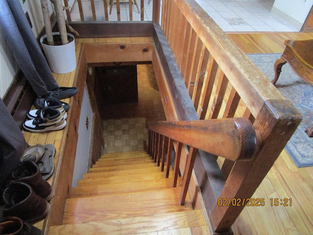 stairway with wood finished floors