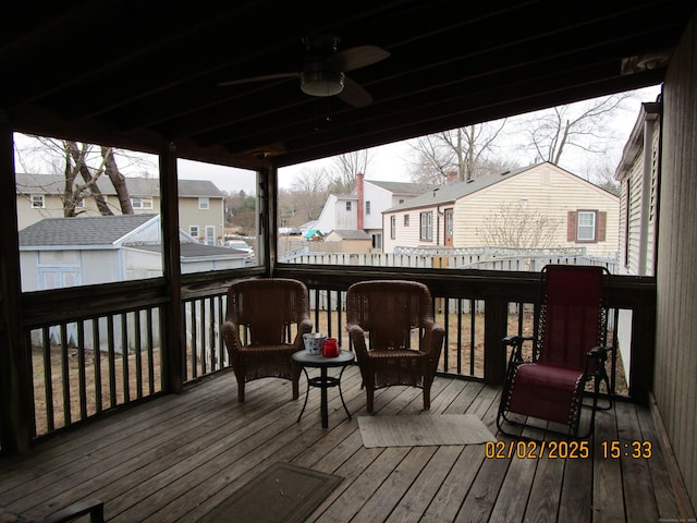 wooden terrace with a residential view and ceiling fan