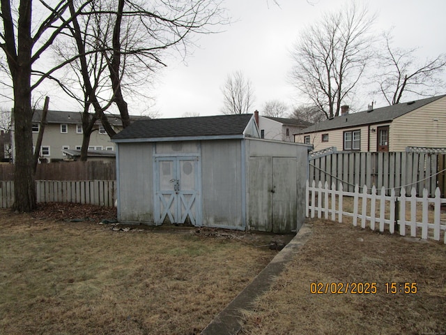 view of shed featuring fence