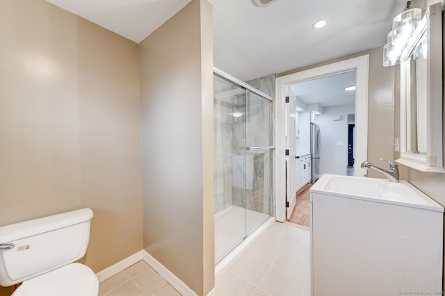 full bath featuring tile patterned floors, toilet, a stall shower, baseboards, and vanity