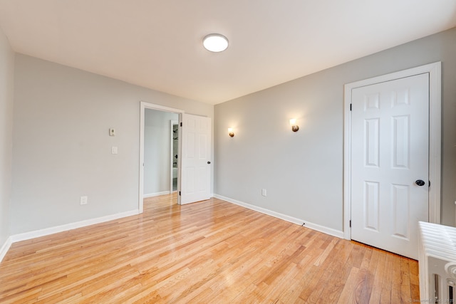 empty room with baseboards and light wood-style flooring