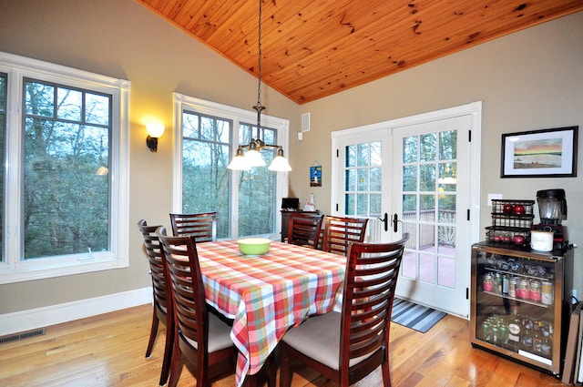 dining area with french doors, plenty of natural light, visible vents, and vaulted ceiling