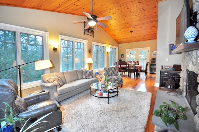 living area with high vaulted ceiling, wood ceiling, ceiling fan, and wood finished floors