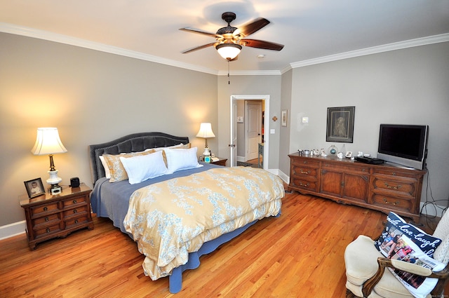 bedroom featuring ceiling fan, light wood-type flooring, baseboards, and ornamental molding