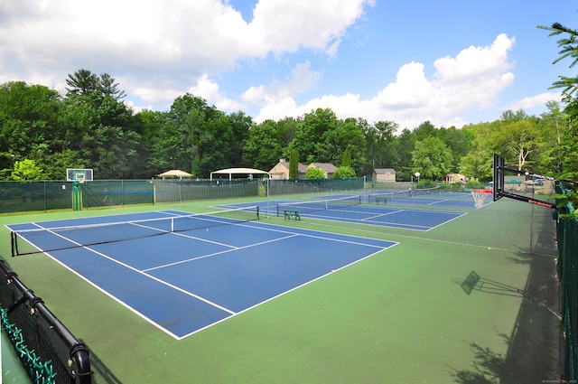 view of tennis court featuring fence