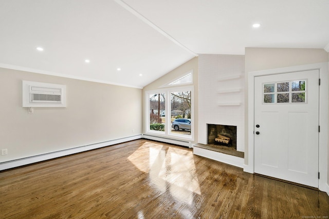 unfurnished living room with wood finished floors, a wall mounted AC, a fireplace, recessed lighting, and vaulted ceiling