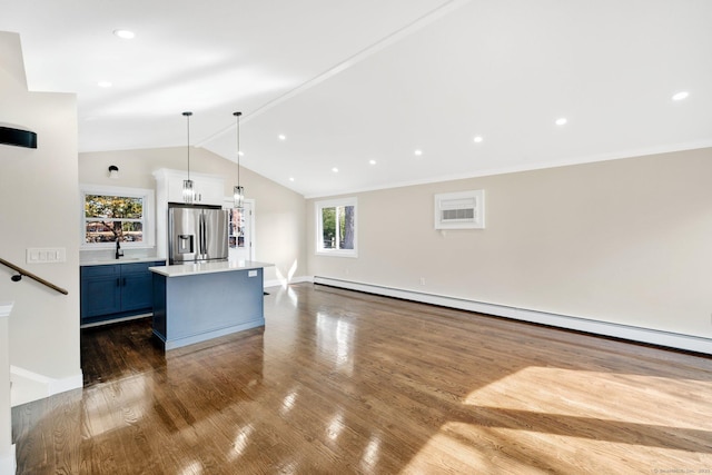 kitchen featuring dark wood-style flooring, light countertops, vaulted ceiling, stainless steel refrigerator with ice dispenser, and baseboard heating