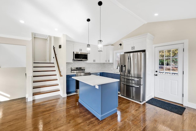 kitchen featuring blue cabinets, a kitchen island, appliances with stainless steel finishes, white cabinets, and light countertops