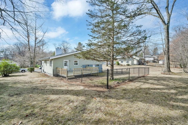 rear view of house with fence private yard and a chimney