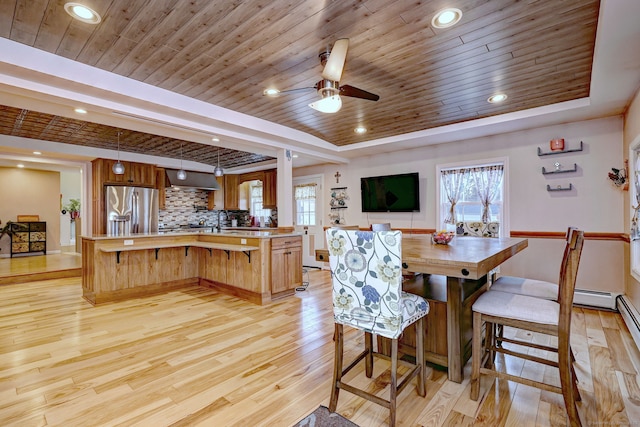 dining area featuring a ceiling fan, light wood finished floors, a tray ceiling, recessed lighting, and wooden ceiling