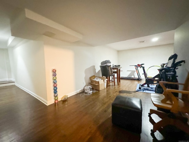 workout room with baseboards and wood finished floors