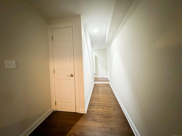 hall featuring dark wood-style floors and baseboards