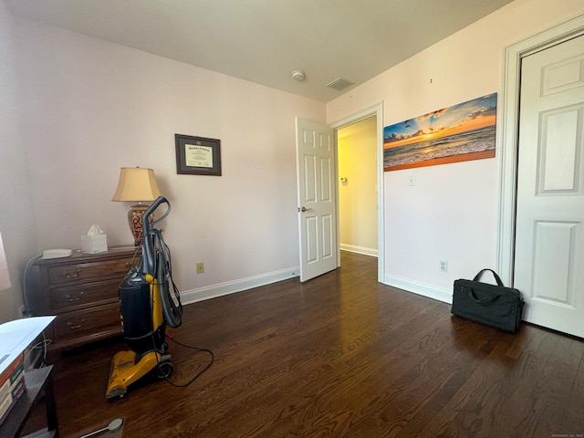 interior space featuring wood finished floors, visible vents, and baseboards