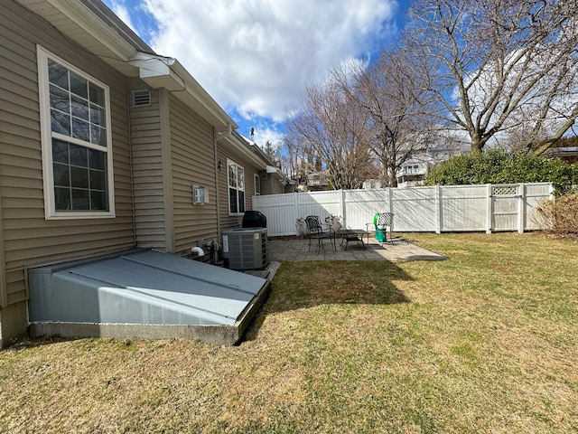 view of yard with fence, cooling unit, and a patio