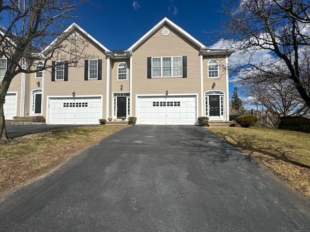 view of front facade with a garage and aphalt driveway