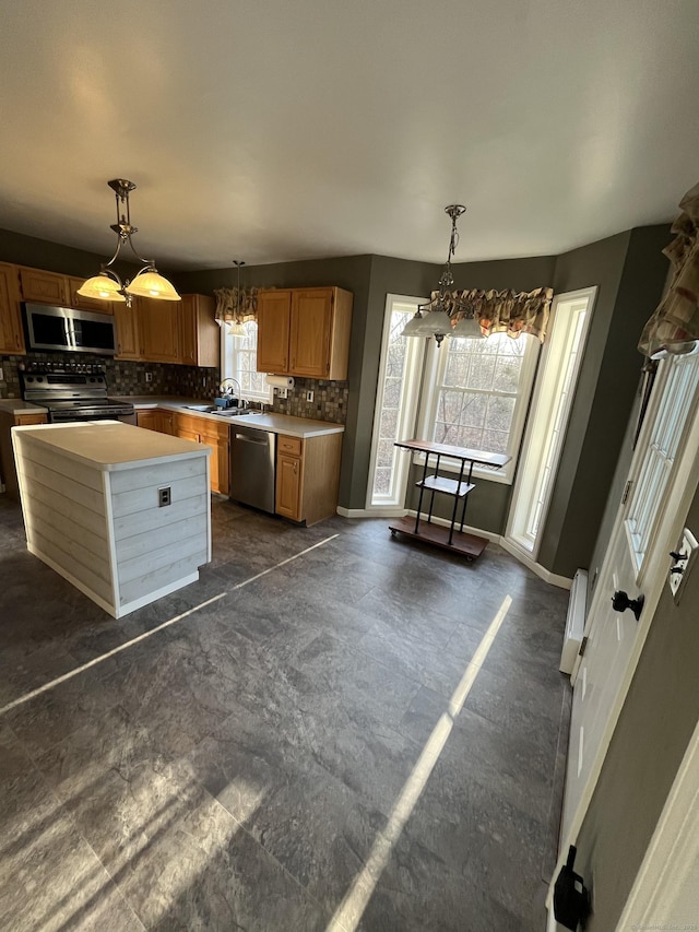 kitchen with tasteful backsplash, stainless steel appliances, light countertops, baseboards, and a chandelier