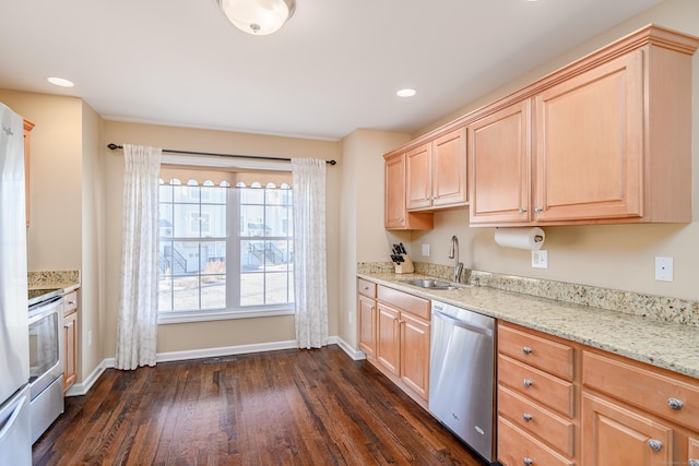 kitchen with light brown cabinets, baseboards, dark wood finished floors, appliances with stainless steel finishes, and a sink