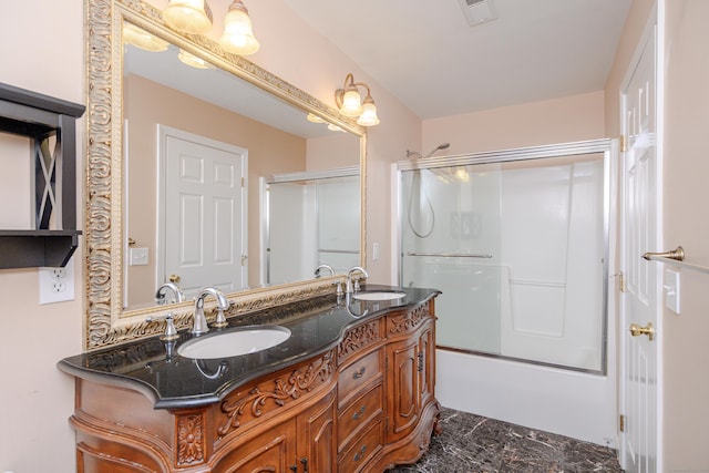 bathroom with a sink, visible vents, combined bath / shower with glass door, and double vanity