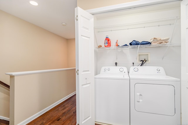 washroom featuring dark wood finished floors, washing machine and dryer, recessed lighting, baseboards, and laundry area