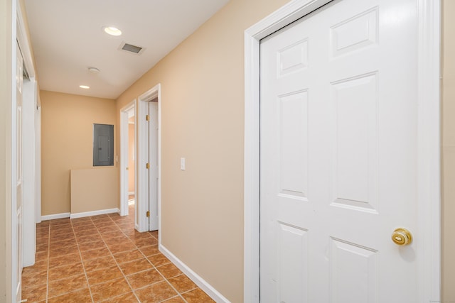 corridor featuring visible vents, baseboards, electric panel, light tile patterned floors, and recessed lighting