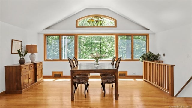 dining space with visible vents and lofted ceiling