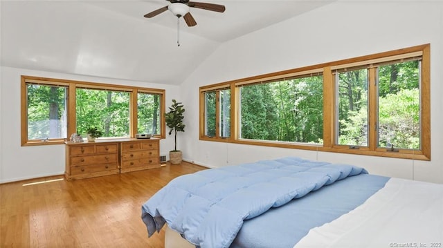 bedroom featuring a ceiling fan, lofted ceiling, and wood finished floors