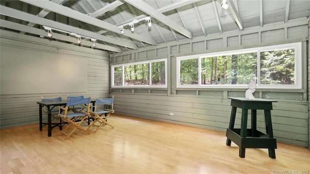 sunroom featuring wooden ceiling, beamed ceiling, and rail lighting