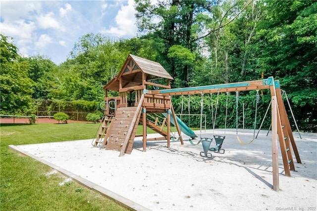 community jungle gym featuring a yard