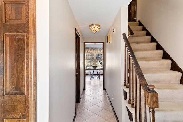 hall featuring stairway and light tile patterned floors