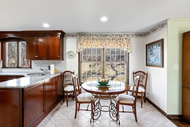 dining room with recessed lighting and baseboards