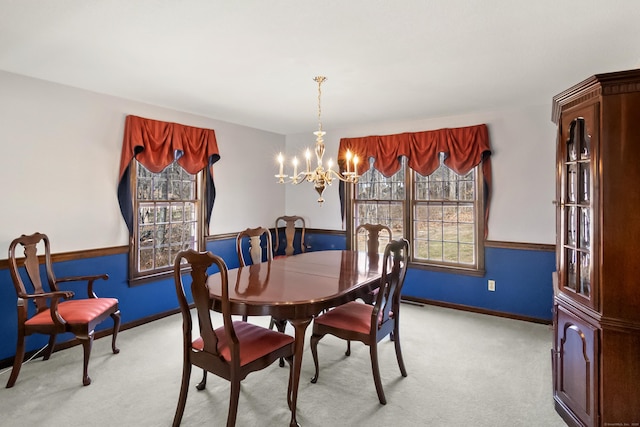 dining area with baseboards, carpet floors, and a chandelier