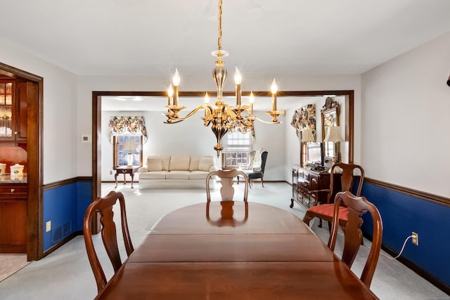 dining area featuring a notable chandelier, light colored carpet, and visible vents