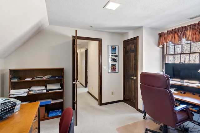 home office with visible vents, light carpet, a textured ceiling, and baseboards